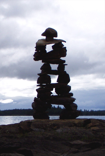 Inukshuk on a rocky point marking the way forward